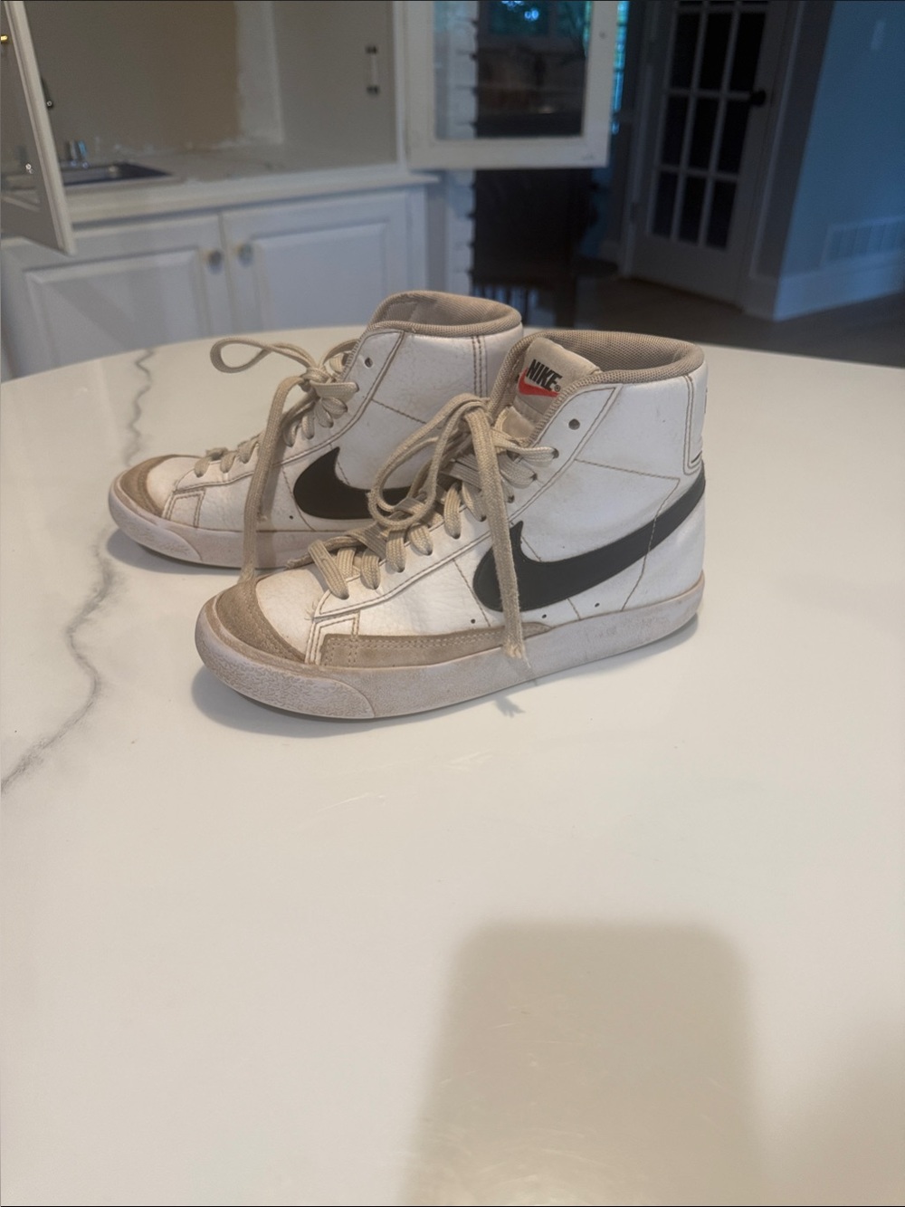 Kids Nike White High-Top Sneakers with Black Swoosh